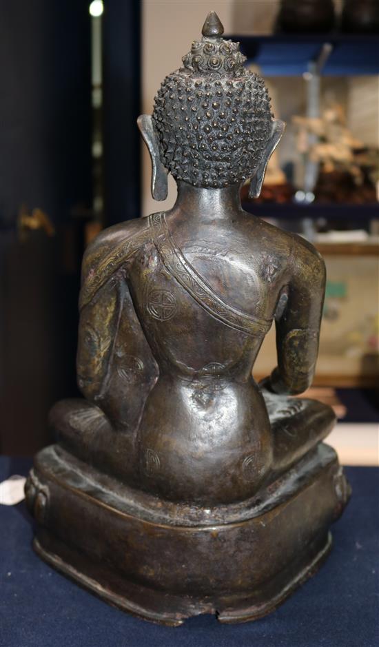 A large Tibetan bronze seated figure of Buddha Shakyamuni, probably 13th century, height 39.5cm, minor old repairs